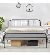 Cadre de lit moderne en métal noir avec un design de tête de lit simple, illustré avec un matelas et des boîtes de rangement en dessous contre un mur blanc.